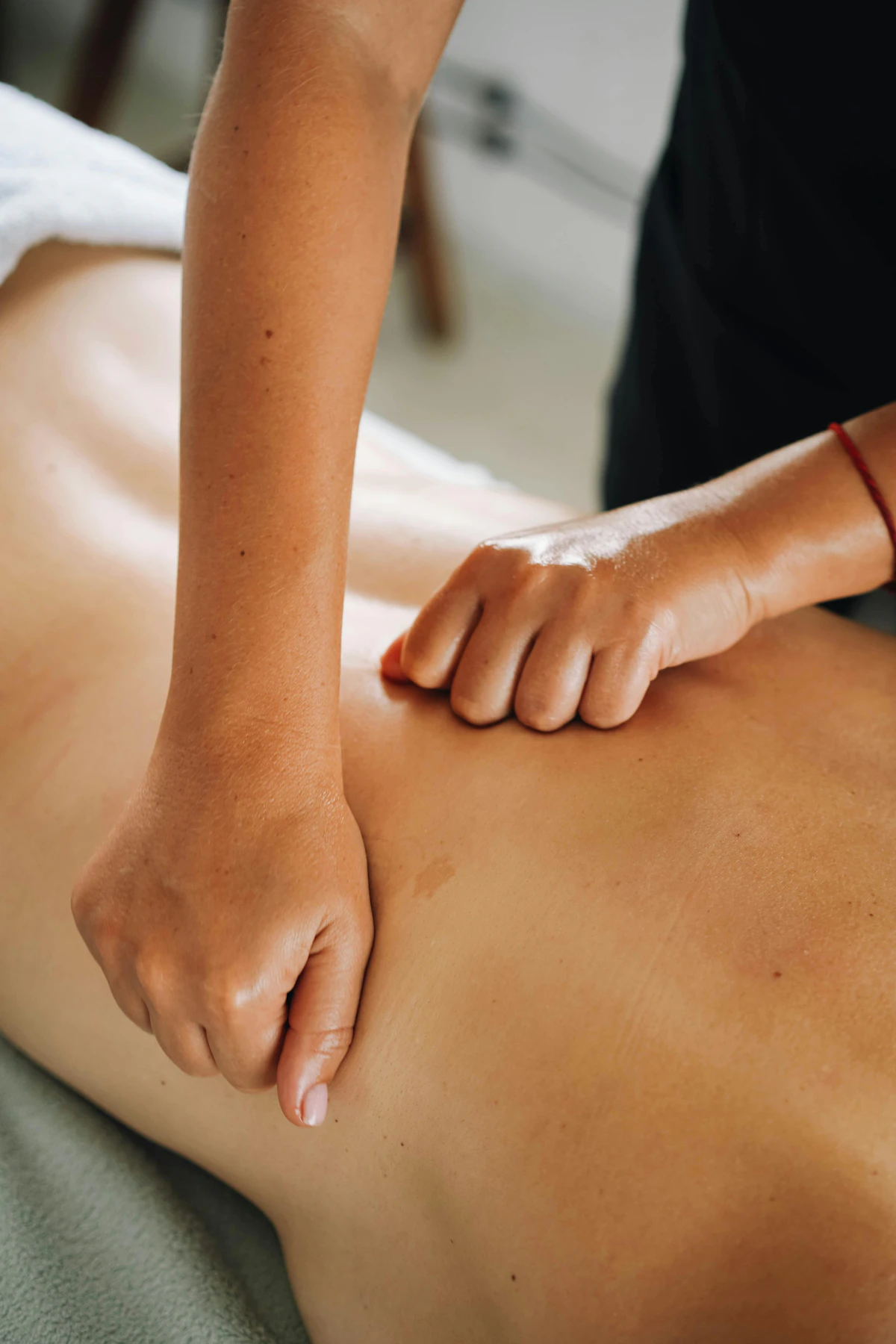 A Thai with Me therapist working slowly through a back massage